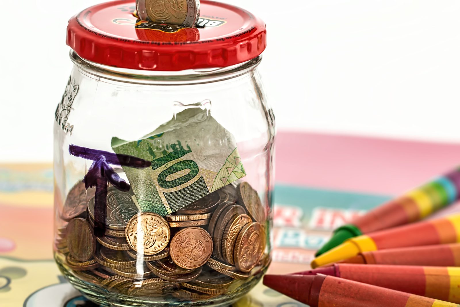 A pink piggy bank, symbolising household savings set aside for school fees